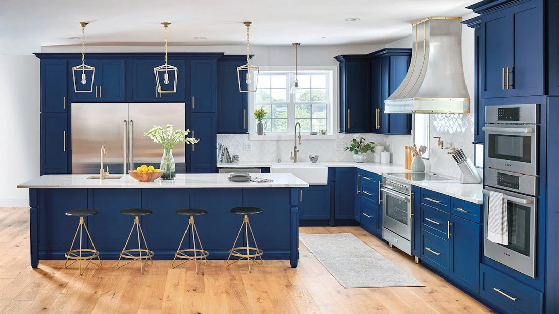 Navy blue shaker kitchen with brass hardware, white quartz countertops, and a large island with bar seating — Rose Hill Cabinets in a luxury Chicago-area kitchen remodel by Lotus Home Improvement.