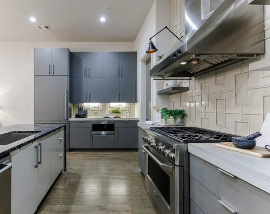 Trending kitchen design with gray cabinets and zellige tile backsplash — design-build renovation by Lotus Home Improvement in the north Chicago suburbs