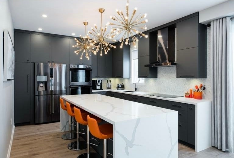 Modern kitchen with matte black cabinetry, white marble island with orange bar stools, and two gold sputnik chandeliers