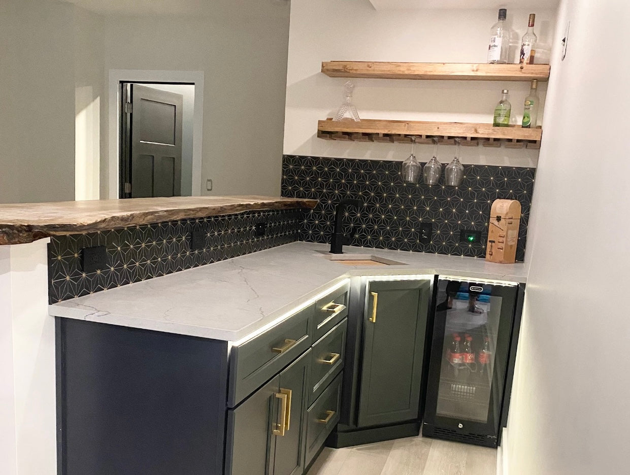Modern kitchen with marble countertop, black cabinets, and wine cooler