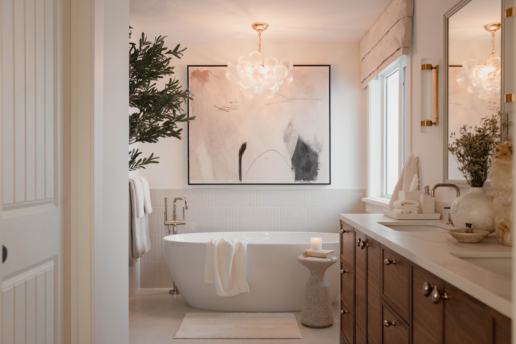 Modern bathroom with freestanding bathtub, sink, and decorative elements