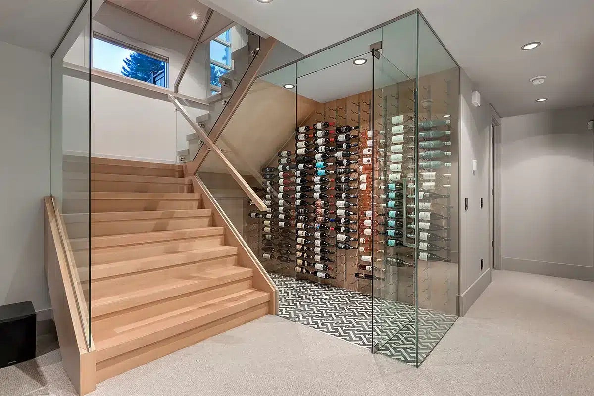 Wooden staircase leading to a wine cellar with glass walls