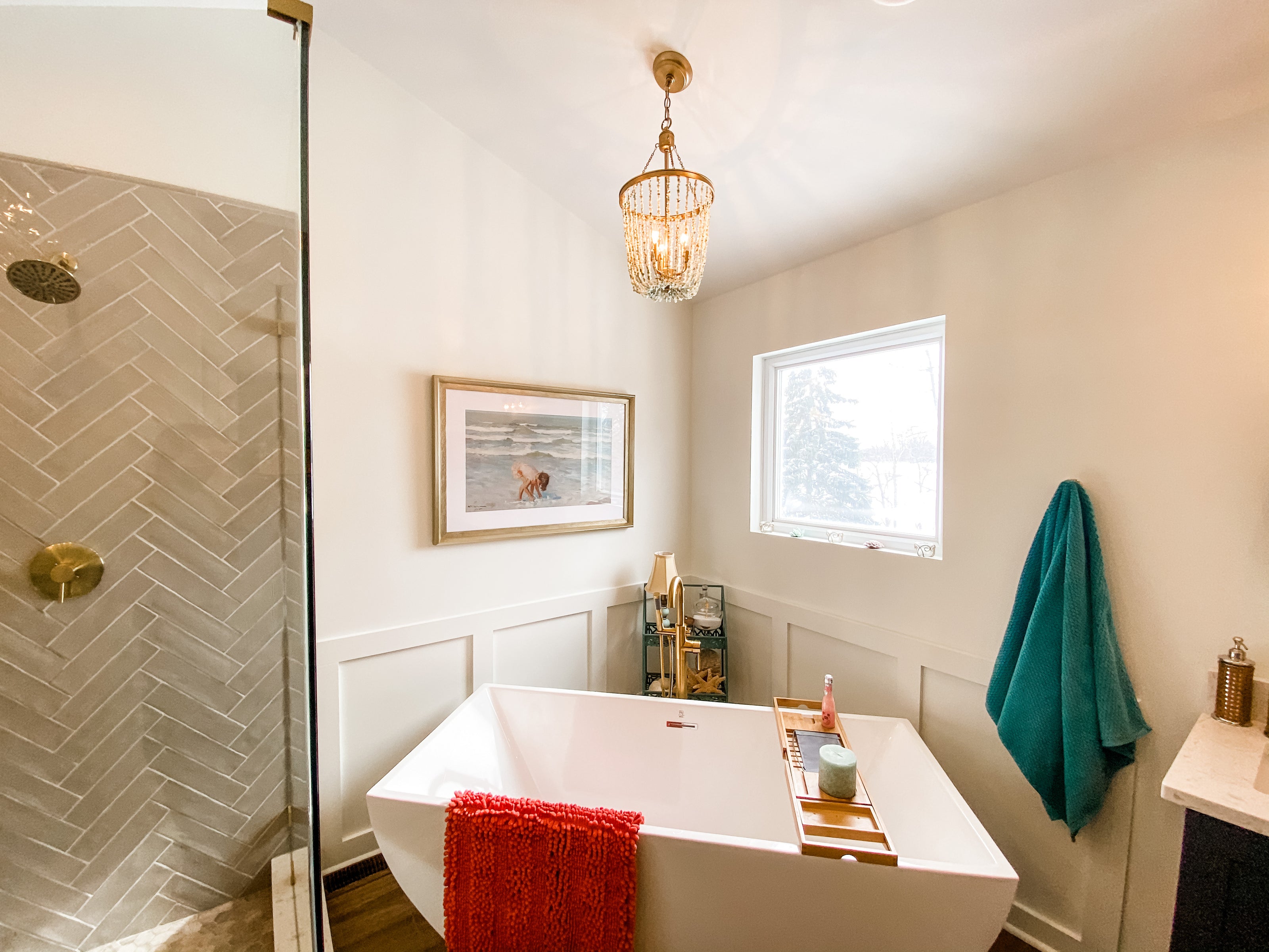 Bathroom with a bathtub, shower, and decorative elements